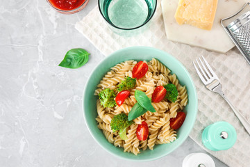 Flat lay composition with tasty pasta on light grey marble table