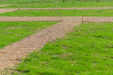 marking garden paths on the construction site. Countryside house building