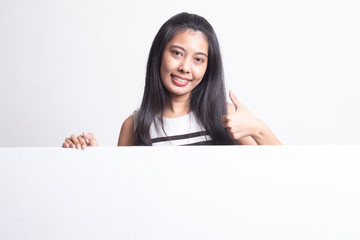 Young Asian woman show thumbs up with blank sign.