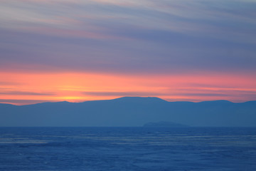 panorama purple sunset in winter mountain,misty hills mountain tops in pink dawn