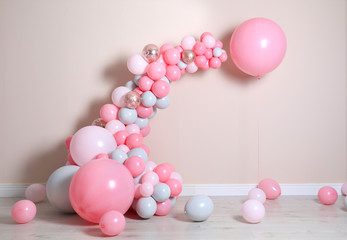 Beautiful composition with balloons near beige wall