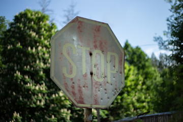 Old rusty stop roadsign in Chornobyl exclusion zone