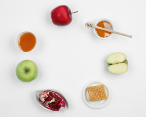 Honey, apples and pomegranate on white background, top view with space for text. Rosh Hashanah holiday