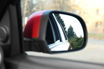 Side rear view mirror of modern car outdoors, closeup