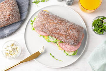 Tasty sandwich with ham served on white wooden table, flat lay