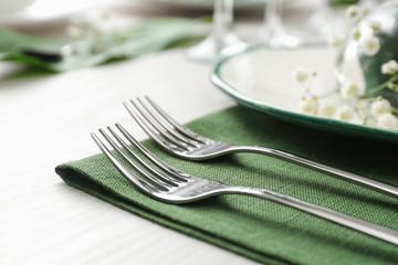 Stylish clean forks on white table, closeup. Festive setting