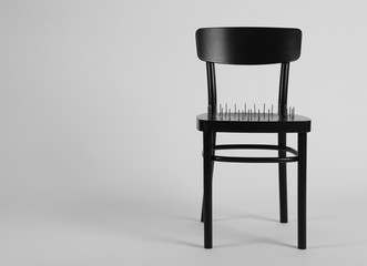 Chair with iron nails isolated on white. Hemorrhoids concept