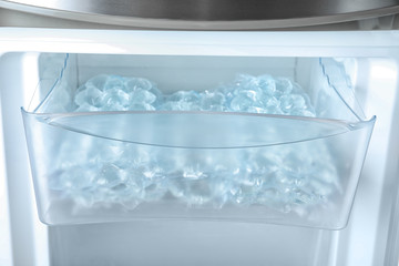 Plastic bags with ice cubes in fridge