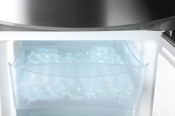 Plastic bags with ice cubes in fridge