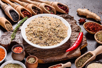 Spices and herbs over black stone background. Top view with free space for menu or recipes