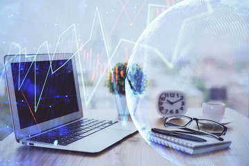 Stock market graph on background with desk and personal computer. Double exposure. Concept of financial analysis.