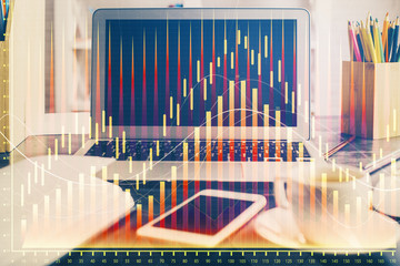 Financial graph colorful drawing and table with computer on background. Double exposure. Concept of international markets.