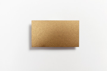 Gold blank matt textured business card flying and isolated on white background, us standard size 3.5 x 2 inches, real professional studio photo.