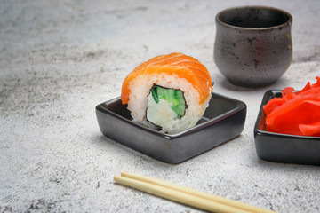 sushi roll on the table with seasoning and sake