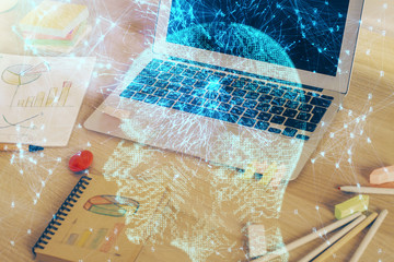 Multi exposure of work table with computer and brain hologram. Brainstorm concept.