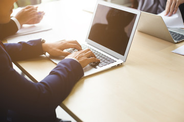 close up laptop with businessman working in office, conference connecting online meeting.