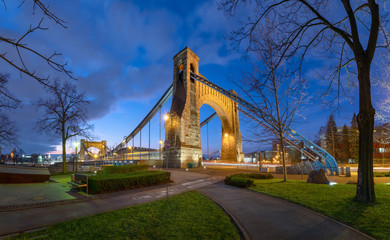 Fototapeta premium Grunwald Bridge (Most Grunwaldzki) over Oder river at dusk in Wroclaw, Poland