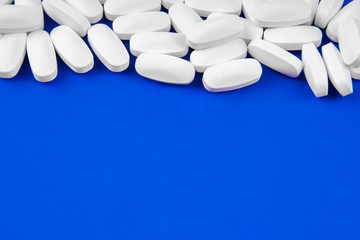 Medical pills on a blue background copyspace, mock up