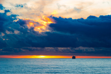 Sea sunset landscape with ship on the horizon