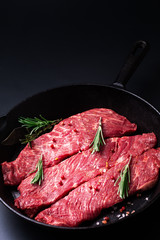 Food concept organic raw meat filet beef steak in skillet iron pan on black background