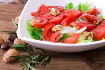 Vegetable salad with nuts and olives, diet and health concept