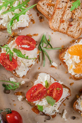 Mini canapes with cheese, tomatoes and tangerines