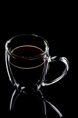  cup with black coffee stands on black glass