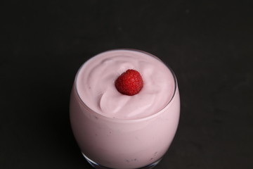 delicious raspberry yogurt in color background
