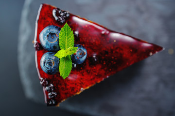Cake with berry fruits, chia cereals and nuts isolated on black background