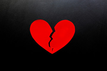 Broken heart made from red paper on black background, represent Love.