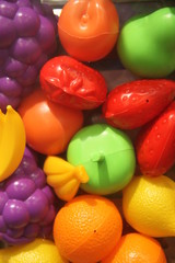 Fototapeta na wymiar Multicolored plastic toys fruits kindergarten