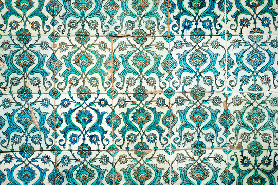 Medieval era glazed tile wall of intricate blue hand painted floral patterns in a Turkish Islamic mosque in Istanbul, Turkey dating back to 1459