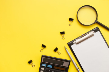 Search or choose a job. Career or office desk concept. Office supplies, blank and magnifier on a yellow background.