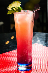 Closeup of non alcoholic cocktail with ice and lemon and with pineapple.