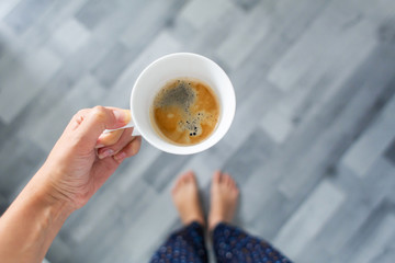 top view of a cup of coffee in hand. Morning aromatic coffee.