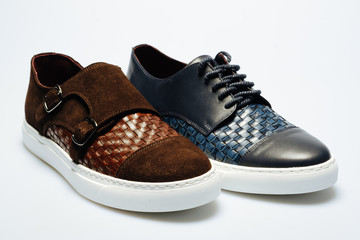 brown and blue leather shoes on a white background