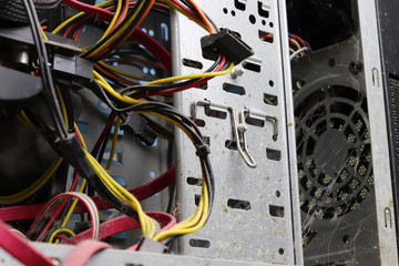 A lot of dust in the system unit of the computer. Copy space - the concept of cleaning and repairing old equipment, short circuit wiring.