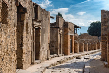 Fototapeta premium A street in the antique ruins of pompei, city destroyed by the vesuvius volcano eruption in Italy, site inscribed on the world list heritage of UNESCO