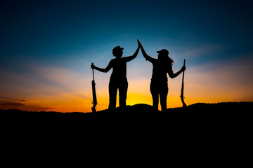 Hunters and rifle silhouette women