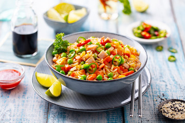 Asian fried rice. Blue wooden background. Close up.