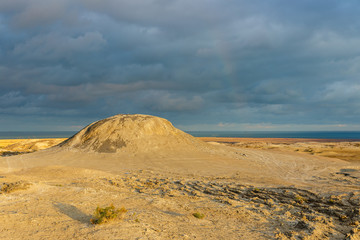 Mud volcanoes of Gobustan near Baku, Azerbaijan. mud mountain and stormy sky