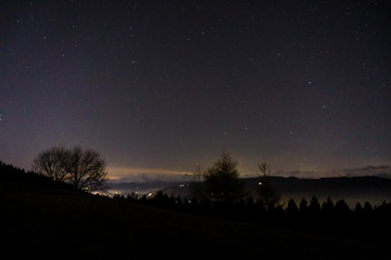 Obraz na płótnie Canvas The view and landscape during a starry night, near the village of San Fermo, Lombardy, Italy - December 2019.