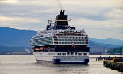 Luxury cruiseship or cruise ship liner arrival into port of Vancouver, Canada with Canada Place...