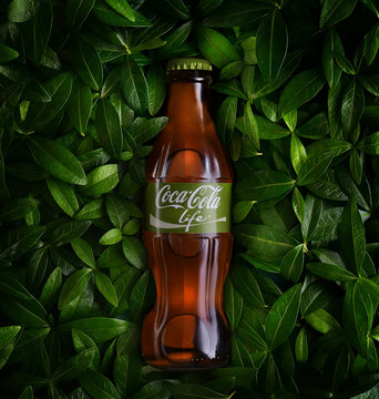 POLTAVA, UKRAINE - February 10, 2019: bottle of Coca Cola Life in the leaves