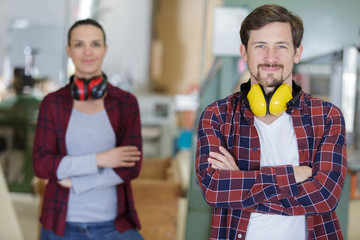 portrait of man and woman in carpentry workshop