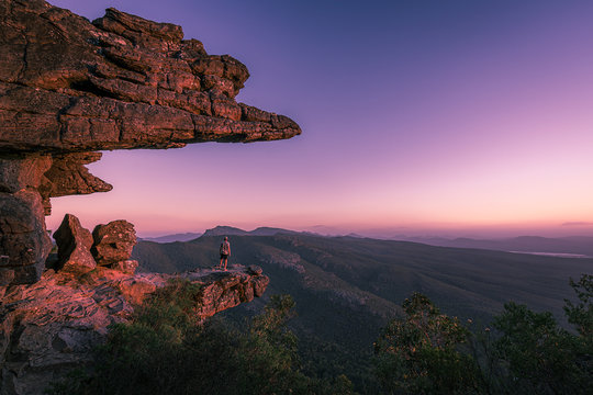 A guy standing on reeds lookout in the Grampians national park, Australia