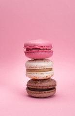 colored macaroons on a pink background