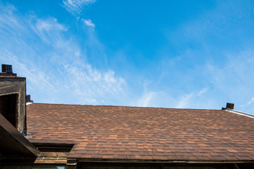 Brown roof of metal roofing on the sky background