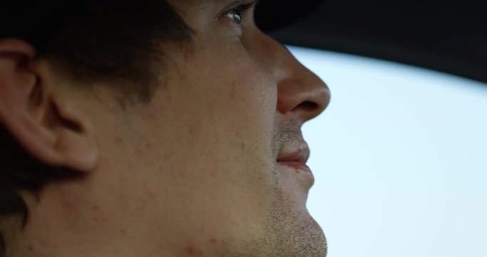 Man driving car - extreme close up on side profile of face