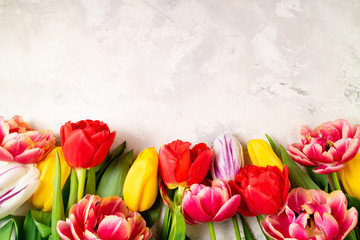 Spring background with tulips spring flowers. Femininity background. Floral pattern. Greeting card, holidays, Easter, Mother's day, 8 March concept. Flat lay, top view, copy space